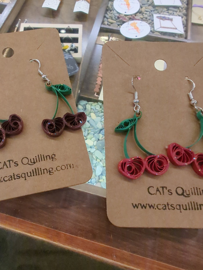 Cat's Quilling earrings featuring delicate quilled cat designs on gold-tone hooks, showcasing intricate craftsmanship.