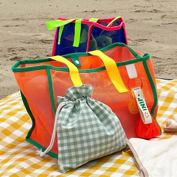 ACCITY mesh beach bag with adjustable shoulder straps, see-through design, and spacious main compartment for beach essentials.
