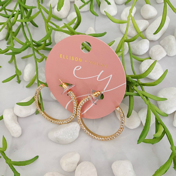 Reversible Ellison+Young hoop earrings with plain and shiny finishes, showcasing their stylish, versatile design.