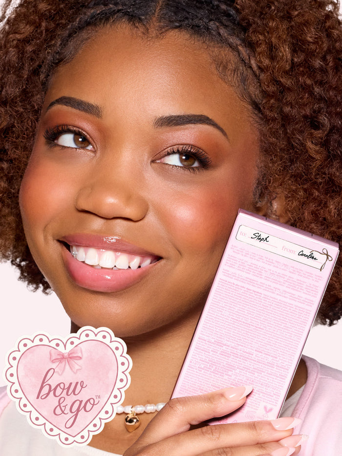 a girl holding tarte maracuja juicy lip duo gift set