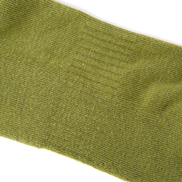 Men's avocado green ankle socks with ribbed knit texture close-up.
