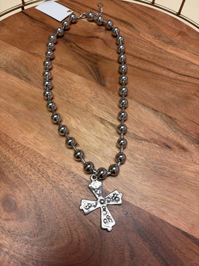 Lula 'n' Lee ball chain cross necklace showing a silver cross pendant on a ball chain necklace.