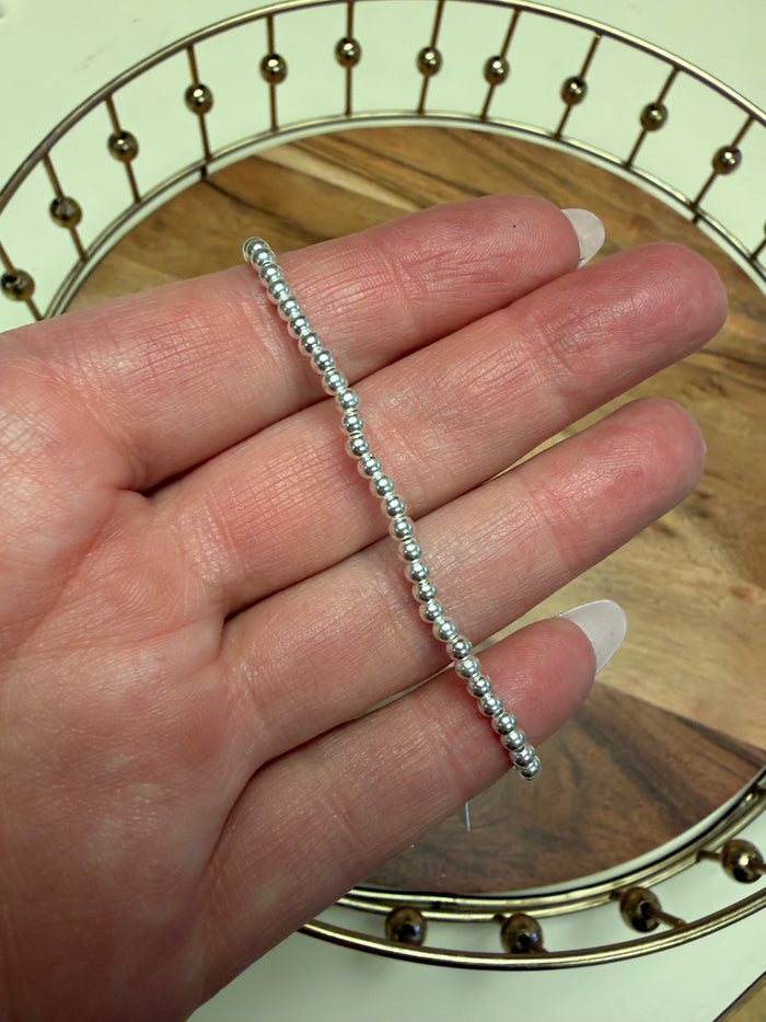 Sterling silver beaded bracelet by Lula 'n' Lee featuring round silver beads on a stretchy cord.