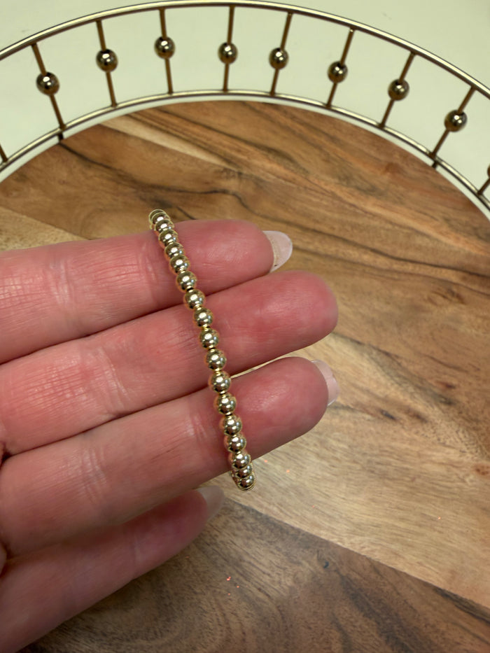 Gold filled beaded bracelet by Lula 'n' Lee featuring small round beads and an adjustable clasp.