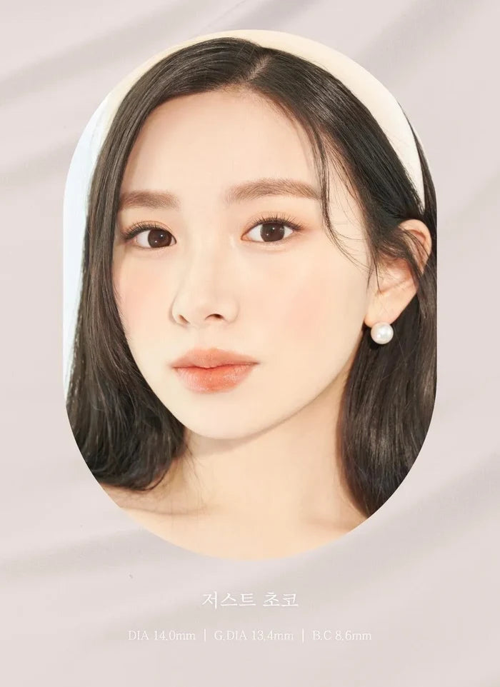 A close-up of a model demonstrating a natural makeup look with Ann365 JUST Choco (Toric for Astigmatism) (1 PAIR) circle colour contacts, highlighting how well the contact lenses blend with her dark eyes.