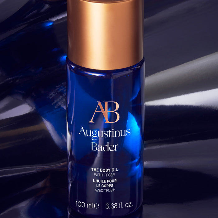 Augustinus Bader The Body Oil bottle with blue glass and gold cap