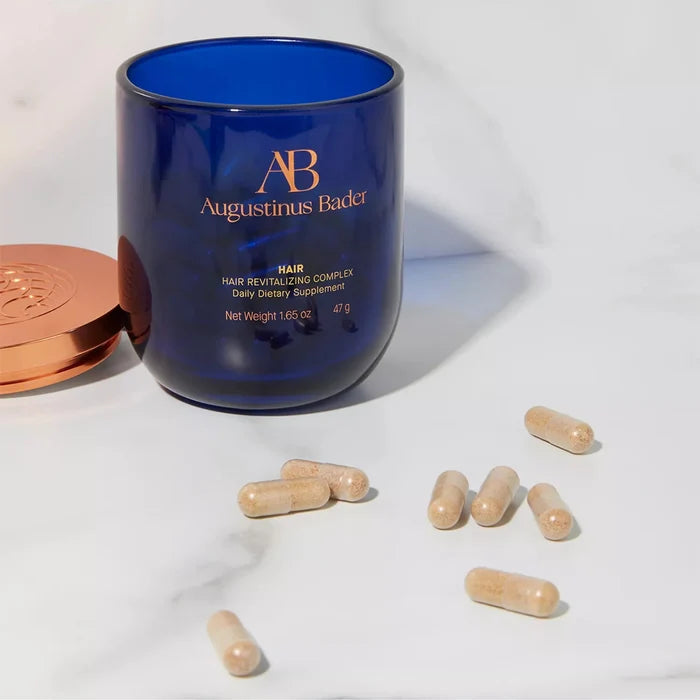 Augustinus Bader Hair Revitalizing Complex daily dietary supplement capsules in blue container