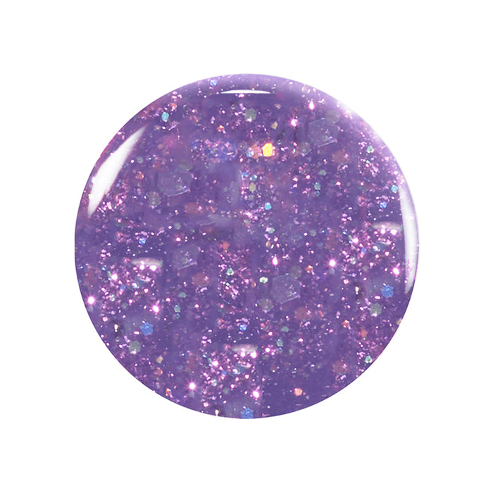 A close-up of a round spot of Betty Scarlett Stella Trio nail polish by Manucurist shows glittery purple, non-toxic polish with sparkles and iridescent flecks on a white background.