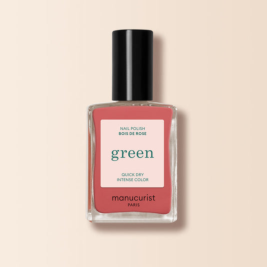 Manucurist's Bois de Rose nail polish features a dusty pink shade with a pink "green" label, delivering quick-dry, intense color on a pale beige background.