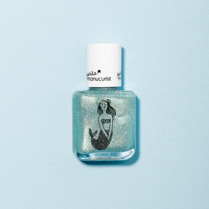 Bonnie the Mermaid by Manucurist is a sparkly, light blue kids' nail polish with a white cap and a black mermaid illustration on the front, shown against a pale blue background.