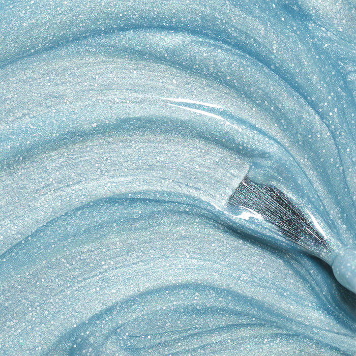 Bonnie the Mermaid by Manucurist is a shimmery, light blue gel with blue glitter and a glossy finish, swirled in smooth waves—ideal as kids' nail polish or removable polish for creative, playful manicures.