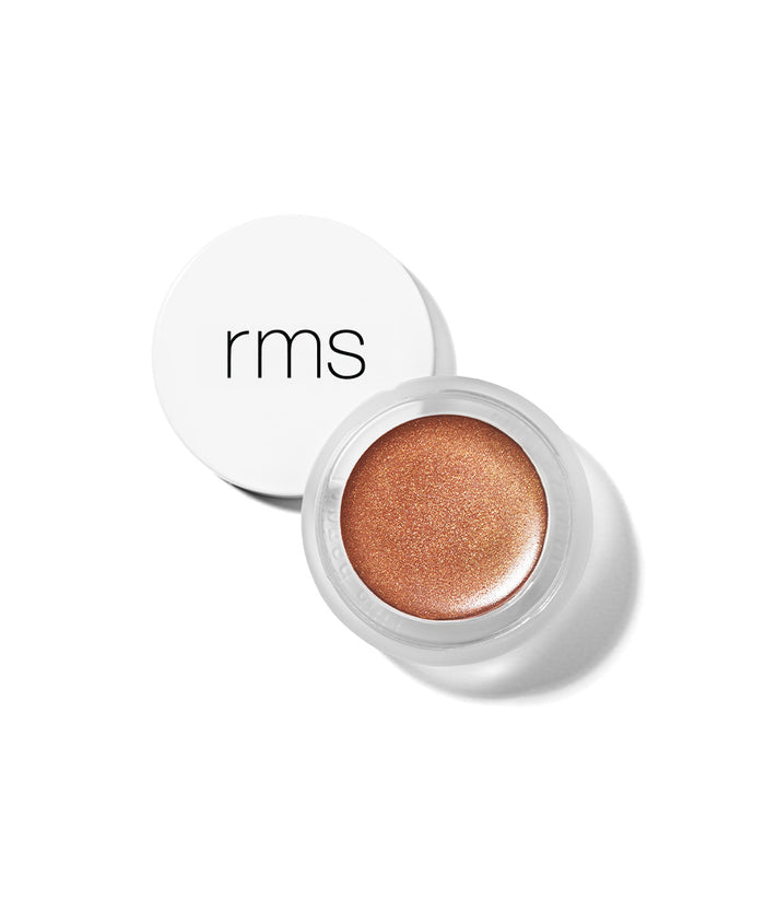 Open jar of Buriti Bronzer showing smooth, shimmering bronze cream makeup in clear container with white lid featuring minimalist black "rms" logo, on white background.