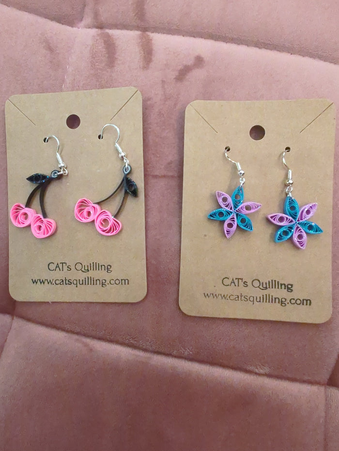 Cat's Quilling earrings featuring intricate quilled cat-shaped designs in vibrant colors and lightweight metal setting.