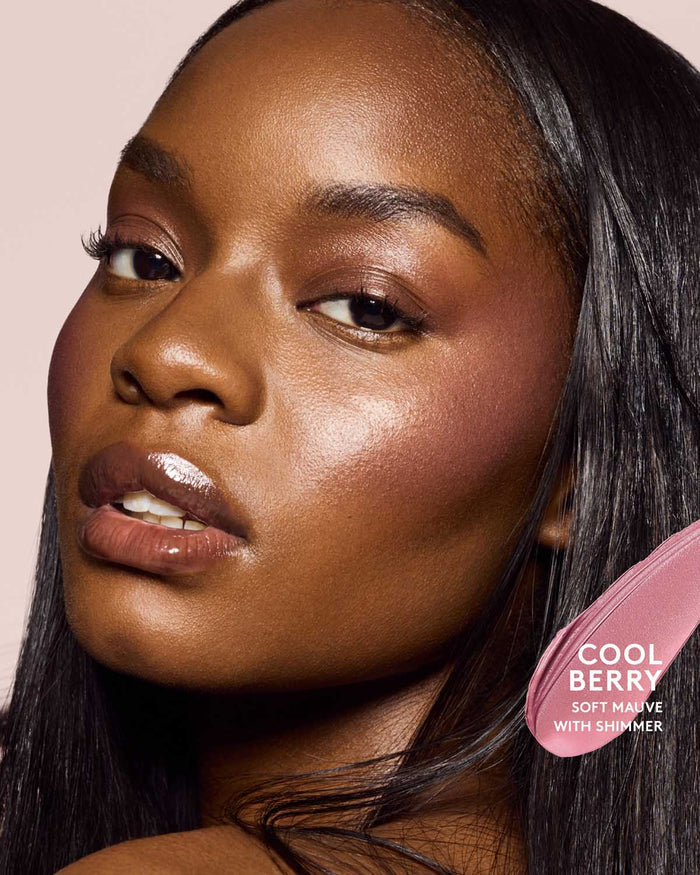 deep skin toned model wearing cheeks out freestyle cream blush in shade cool berry