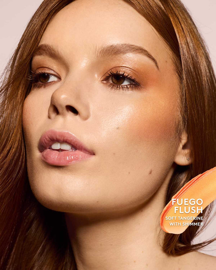 light skin toned model wearing cheeks out freestyle cream blush in shade fuego flush