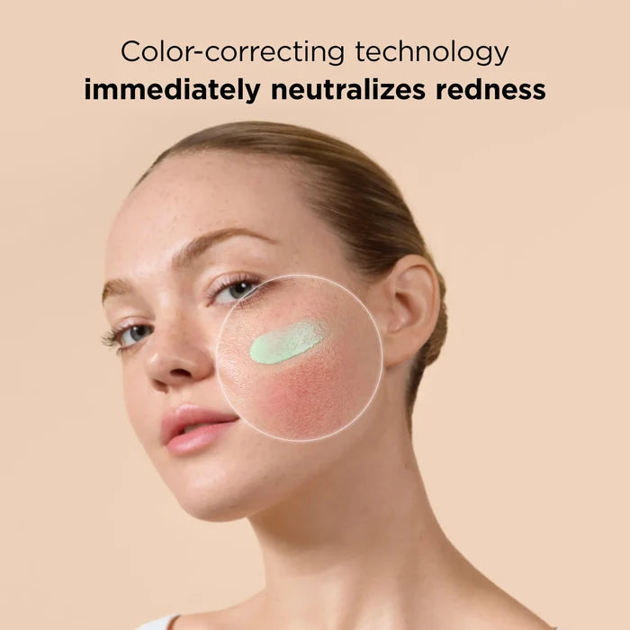 Woman applying green tint sunscreen to cheek; color-correcting technology neutralizes redness