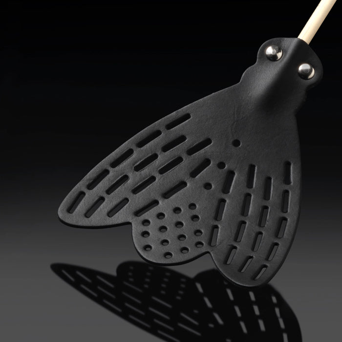 Essey fly swatter head close-up with black perforations, vented slots, metal rivets