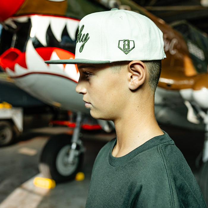 White and olive green snapback hat with Filthy embroidered on the front and BL101 logo on the side