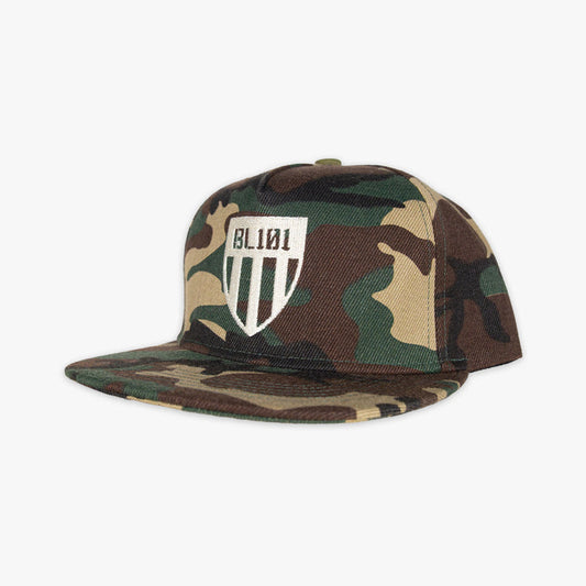 Camouflage snapback hat with white embroidered BL101 shield logo design on the front