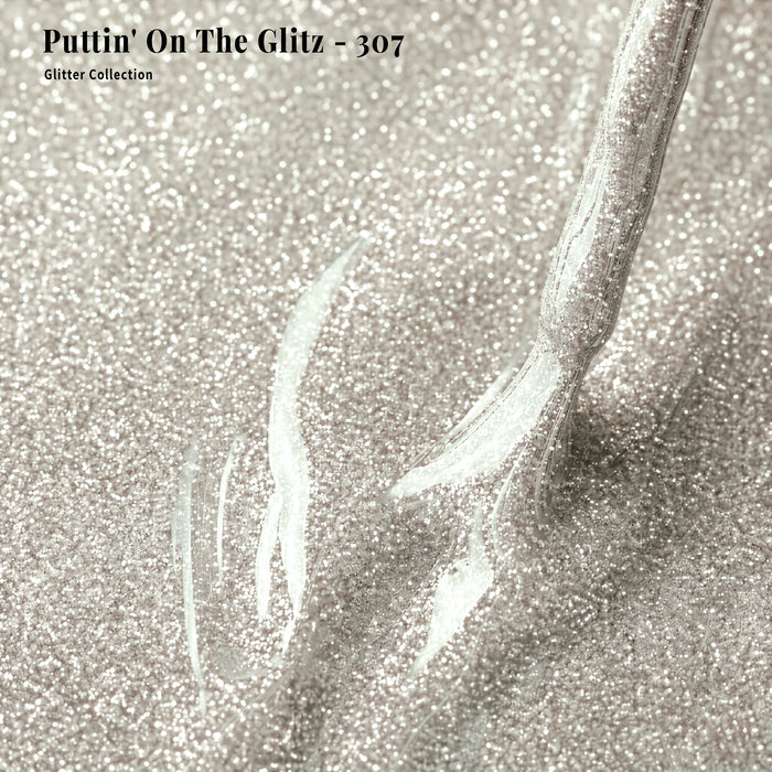 Close-up of glittery gold nail polish with 'Puttin' On The Glitz - 307' text.