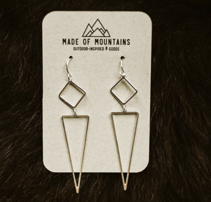 Made of Mountains Geo Dangle Earrings featuring geometric metal design hanging from ear hooks.