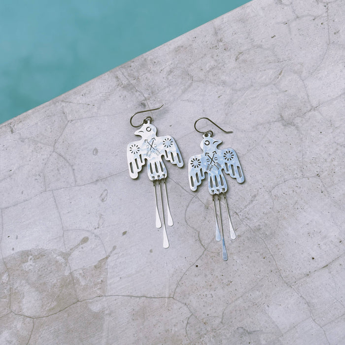 Silver Glide Earrings by Fluff Hardware featuring sleek, minimalist hoop design on a white background.
