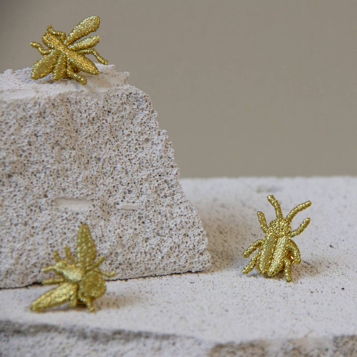 Golden embroidered brooch pins featuring three cute bug designs, perfect for plant lovers and botanical-themed accessories.