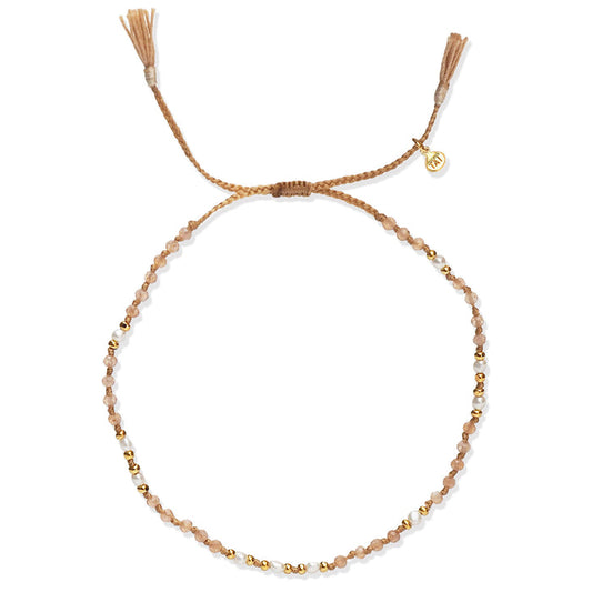 Handmade beaded bracelet with light brown seed beads, gold accents, and small pearl beads