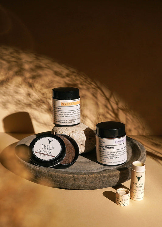 For the Face moisturiser, Limoncello Body Butter, a balm tin and a lip balm arranged on a stone tray.