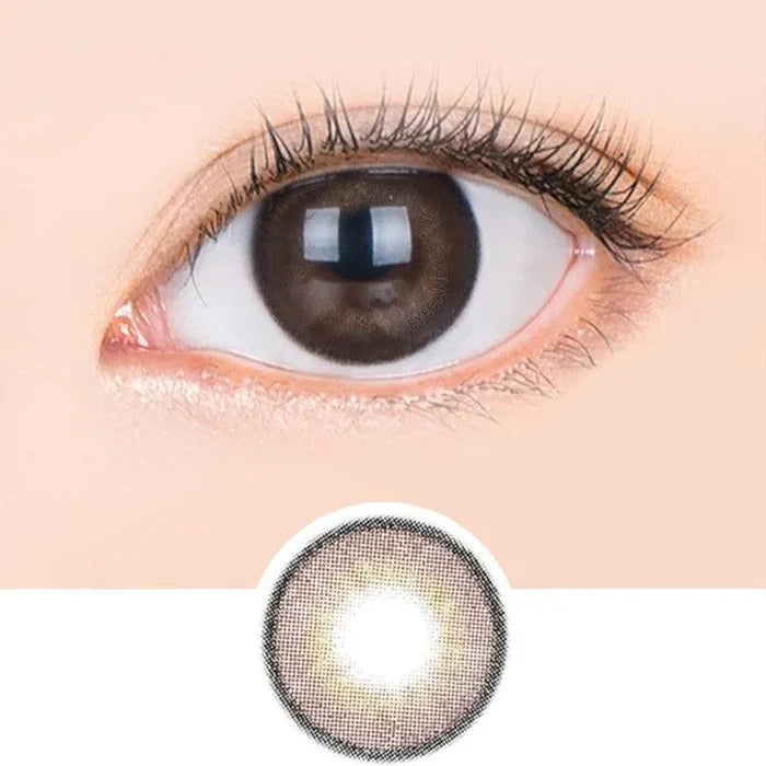 Macro shot of an eye wearing the i-Sha 1-Day Jadey Gem Choco (10pk) prescription colour contact lens, showing the multi-colored detail and natural effect on dark brown eyes, with clean eye makeup. At the bottom is the pattern of the colored lens design, showing the dotted detail and pigmentation.