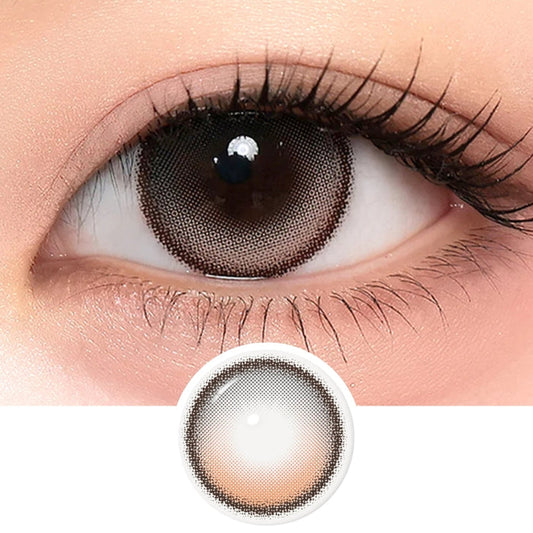 A close-up of a brown eye wearing i-Sha One Pick Only One Cherry Choco lenses by i-Sha, featuring a dark outer ring. Below, the lens image highlights its natural enlargement effect, 3-tone gradient design, and circular border.