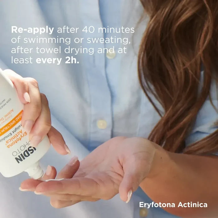 ISDIN Eryfotona Actinica sunscreen being dispensed onto hand with reapply instructions
