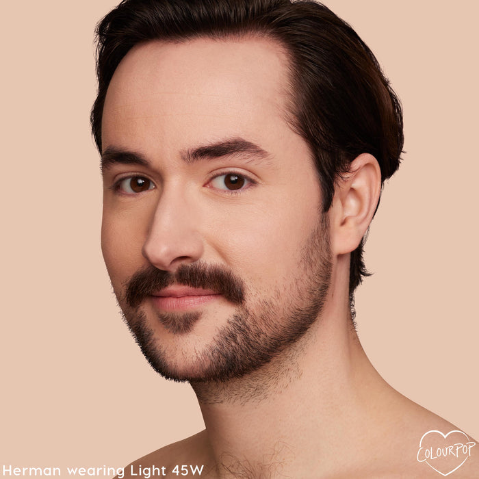 Model wearing Light 45 W shade of ColourPop Pretty Fresh Creamy Concealer, showcasing smooth, natural medium coverage with warm undertones on under-eyes and complexion in a close-up against a soft beige backdrop.
