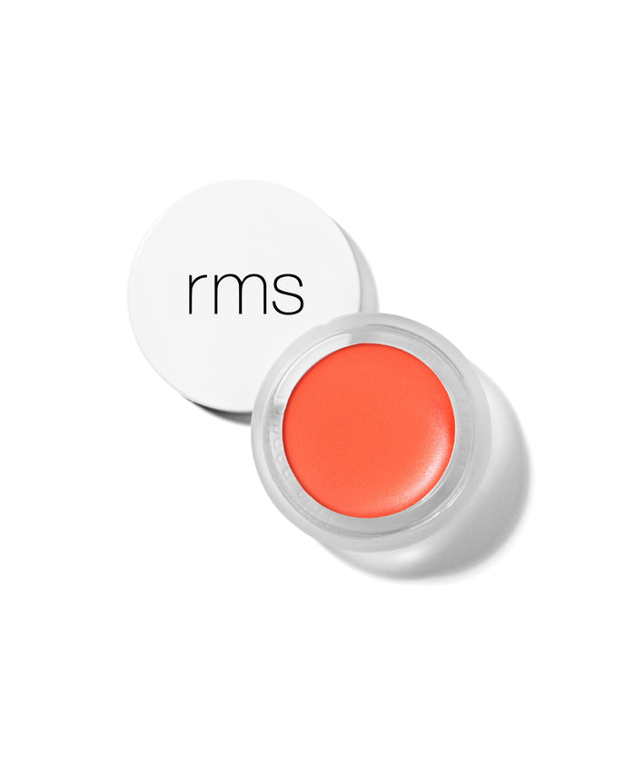 Open jar of vibrant coral cream makeup with white lid featuring simple black "rms" logo, showcasing Lip2Cheek natural, clean beauty product with skincare infused ingredients.