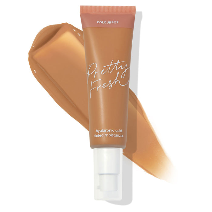 ColourPop Pretty Fresh Tinted Moisturizer tube in Medium Dark 13 W stands over a warm tan swatch, highlighting its hyaluronic acid, pump-top formula for sheer, dewy coverage on medium-dark warm skin tones against a white background.