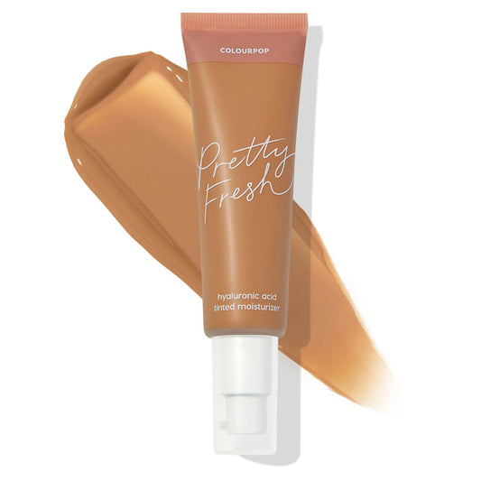 ColourPop Pretty Fresh Tinted Moisturizer tube in Medium Dark 13 W stands over a warm tan swatch, highlighting its hyaluronic acid, pump-top formula for sheer, dewy coverage on medium-dark warm skin tones against a white background.