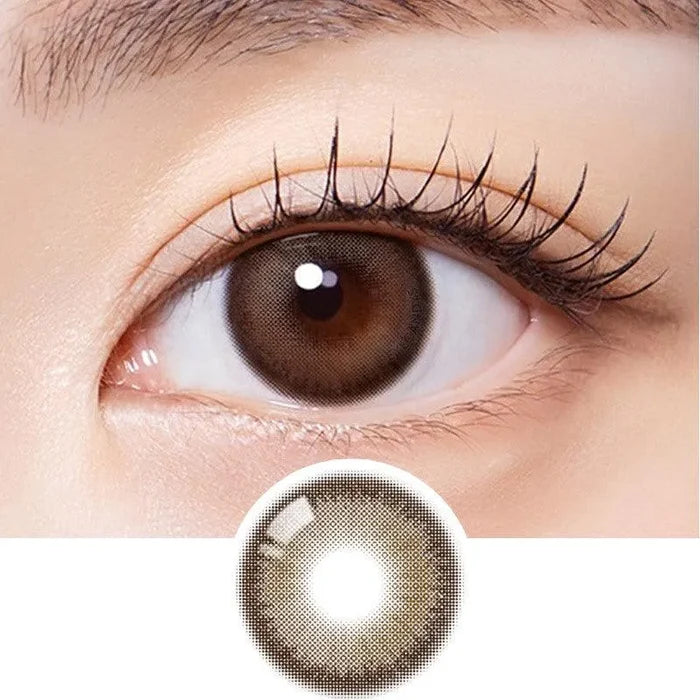 Macro shot of an eye wearing the Olola Muted Choco colour contact lens, showing the multi-colored detail and natural effect on dark brown eyes, with clean eye makeup