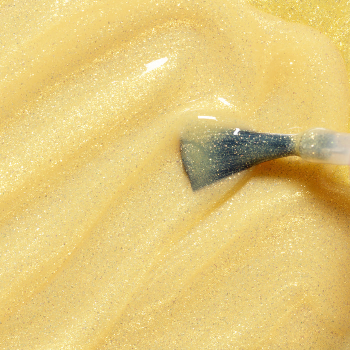 The Manucurist Pia the Bee brush glides shimmery yellow glitter kids' nail polish smoothly, leaving nails with a sparkling, glossy finish.