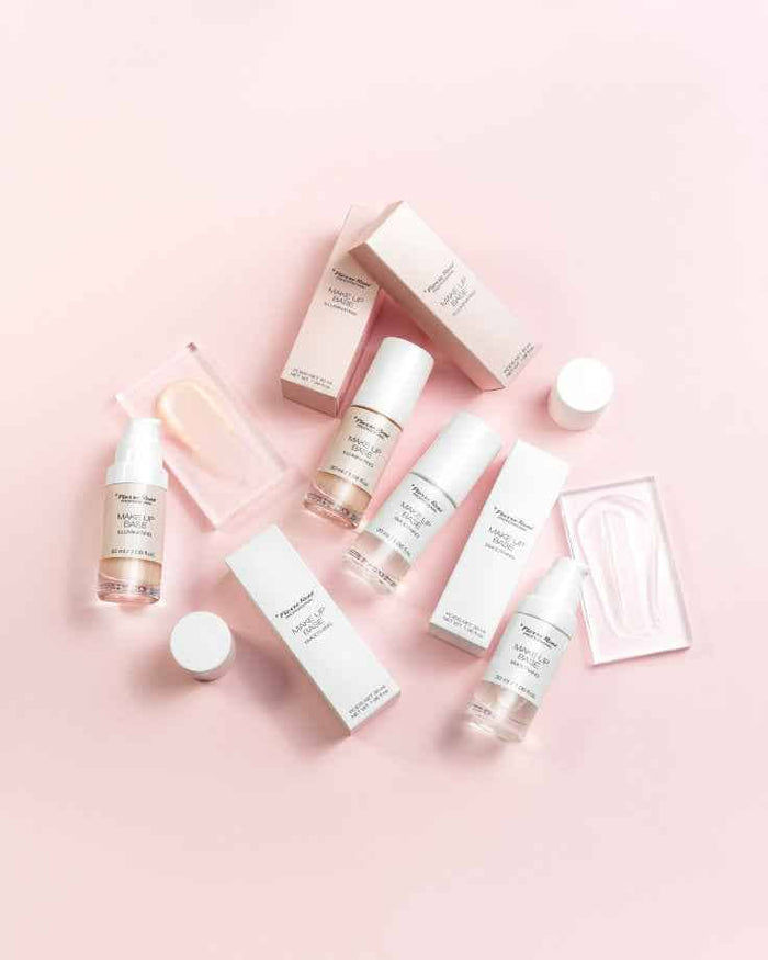 Pierre Rene illuminating makeup base bottles and packaging displayed on a pink background
