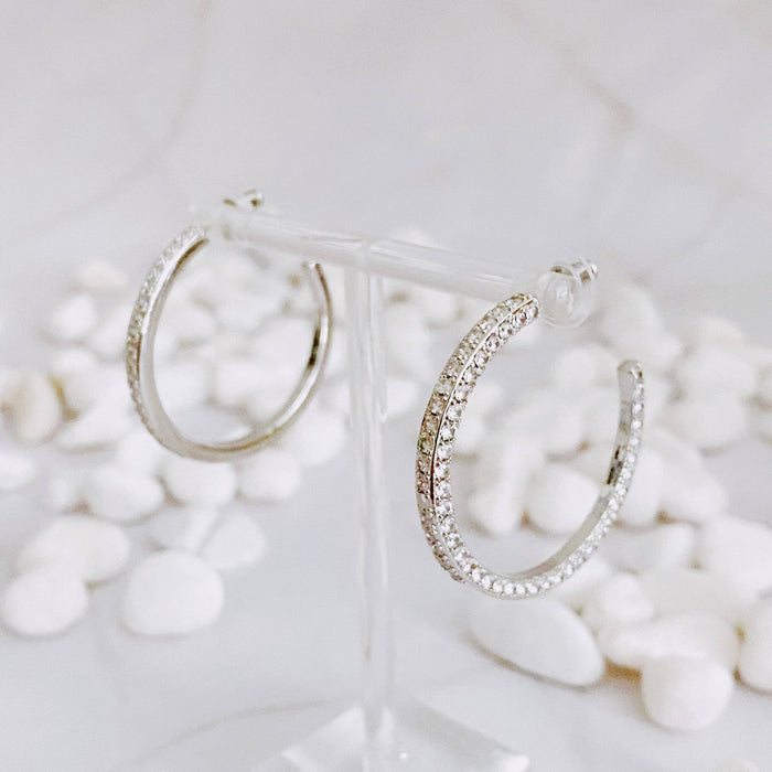 Reversible hoop earrings by Ellison+Young featuring plain and shiny finishes, shown in a close-up image.