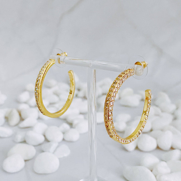 Reversible hoop earrings by Ellison+Young featuring plain and shine finishes, shown in a close-up image of the stylish jewelry.