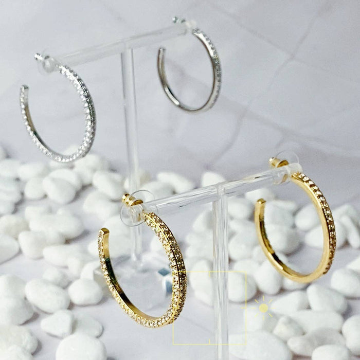 Reversible hoop earrings by Ellison+Young featuring plain and shiny surfaces, displayed in a close-up image.