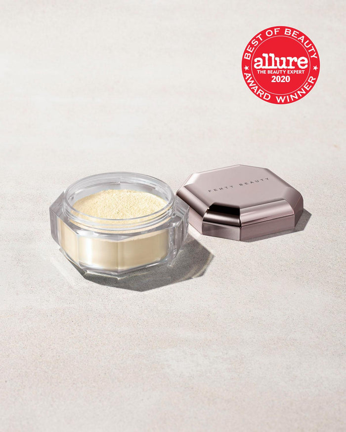 Open container of Pro Filt'r Instant Retouch Setting Powder in shade butter on a concrete background. Allure best of beauty award winner 2020 badge on the top right.