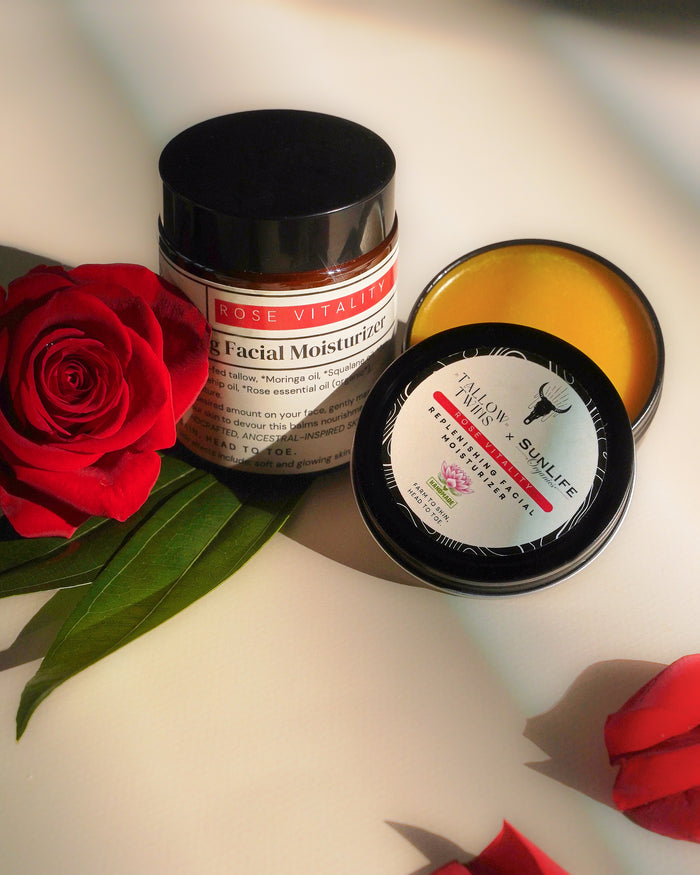 An open jar of Rose Vitality Replenishing Facial Moisturizer beside red roses.
