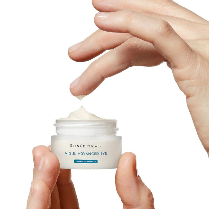 Open SkinCeuticals A.G.E. Advanced Eye cream jar with cream on fingertip