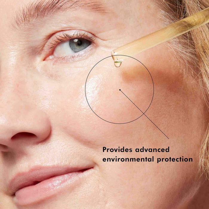 Woman applying vitamin C serum to cheek, with text 'Provides advanced environmental protection'