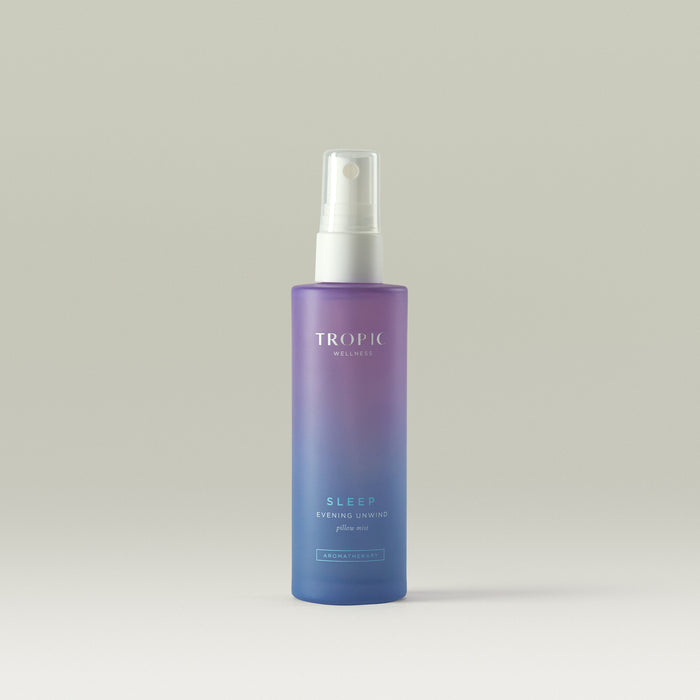 Tropic Pillow Mist in a ambre purple blue bottle, containing lavender, chamomile, and frankincense essential oils to promote relaxation and restful sleep.