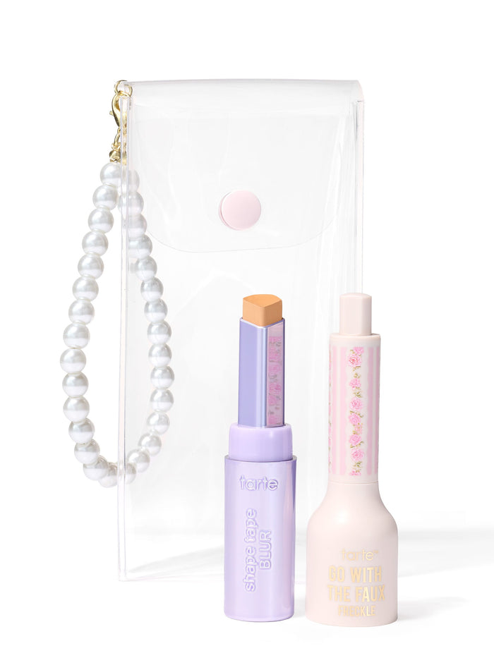 a clear pouch with a pearl strap, a shape tape blur stick and go with the faux freckle stamp all on a white background.