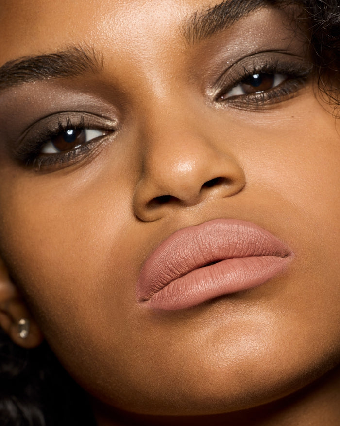 medium skin toned model wearing stunna lip paint in the shade unbutton
