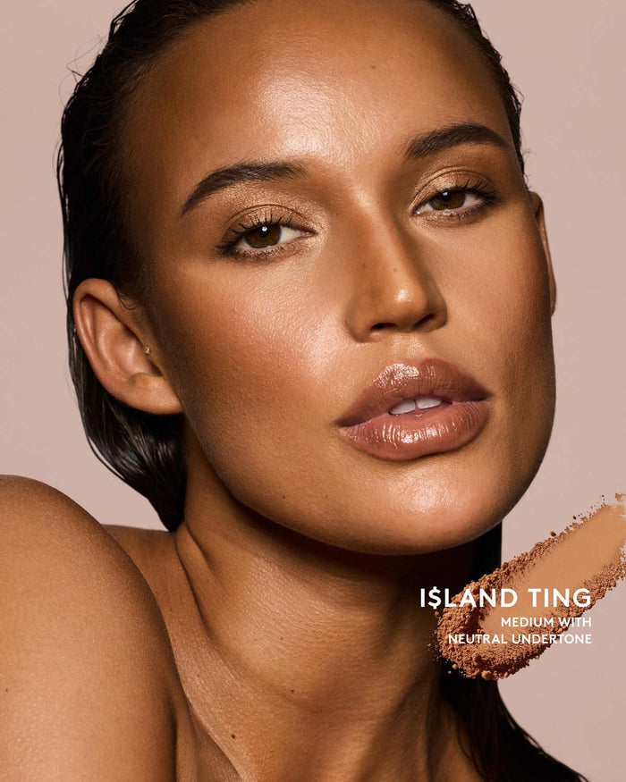 Medium skin tone model wearing sun stalk'r bronzer in shade I$land Ting.
